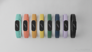 Flat lay photography of several fitness activity bands/smartbands on a light gray surface. Modern wearable devices with co...